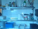 a refrigerator with many dishes on the shelves in the kitchen