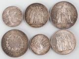 six different types of silver coins are shown on a white surface