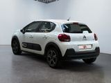 the rear end of a white citrole parked in a white room