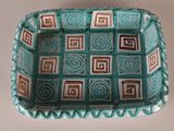 a blue and brown bowl with squares and squares on it