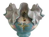 a blue and white vase with flowers in it