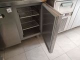 a stainless steel refrigerator with a door open in a kitchen