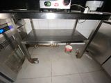 a small kitchen with a stainless steel counter and a microwave