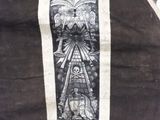 a picture of a black and white drawing of a sun on a vest