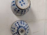 three blue and white vases sitting on a white table