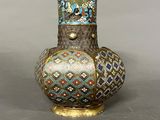 a vase with a decorative design on it on a table