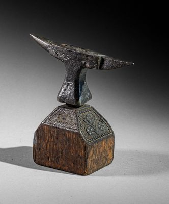 bronze statue of a bird on a wooden block with a black background