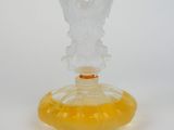 yellow glass angel figurine sitting on top of a yellow vase