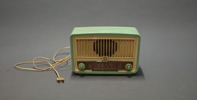 a green and yellow radio sitting on a gray surface
