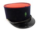 a black hat with a red top and a green leaf on it