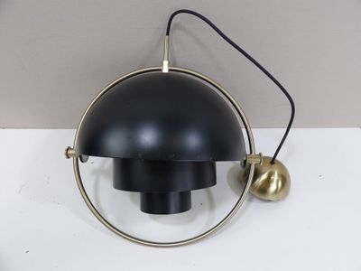 a black lamp that is on a white table