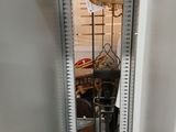 a mirror in the corner of a room with a lamp on