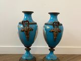 two blue vases sitting on a wooden floor