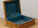 a small blue box sitting on top of a wooden table