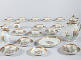 many different types of porcelain dishes and cups on the table