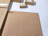 three boxes of brown paper sitting on a white table