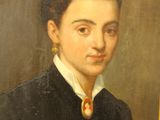 portrait of a young woman in a black dress with a red and white tie