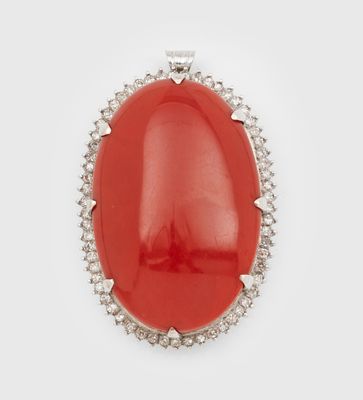 un pendentif ovale en corail et diamants sur fond blanc