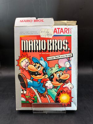 une image représentant une boîte de Mario Bros posée sur une table