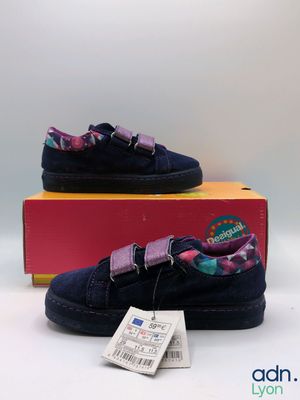 the children ' s shoes are in a box on a white surface