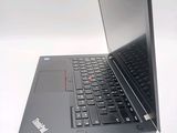a laptop that is open on a white surface