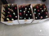 many bottles of wine sitting in a box on the floor