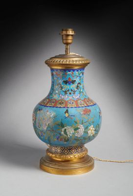 une image représentant un vase bleu et or avec un socle doré