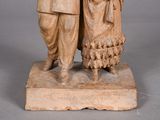 statue of a man and a woman with a sheep on a stone base