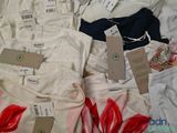 a lot of underwear on a bed with price tags on them