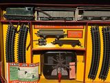 a train set in a yellow box with a red handle
