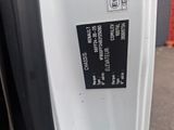 a sticker on the side of a white refrigerator