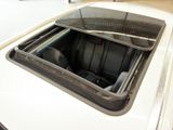a white car with a black seat in the back