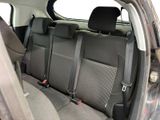 the back seats of a car are black and grey in color