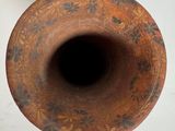 a brown vase that is sitting on a table