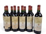 six bottles of wine are lined up on a white surface