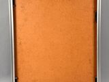an old picture frame with a piece of paper attached to it