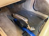 a car that has a tool in it that is sitting on the floor