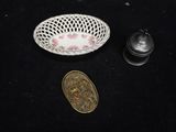 a small bowl and a coin sitting on a table