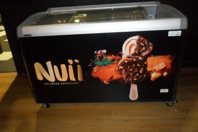 a picture of a small ice cream machine with chocolates on it
