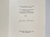 an open book with a handwritten poem on it sitting on top of a table