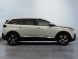 the white suv is parked in a room with a gray floor