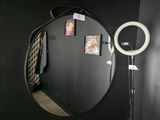 a black wall with a mirror and a light on it