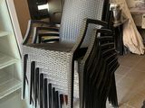 a lot of chairs that are stacked up in a room