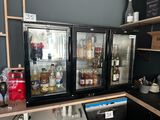 many bottles of alcohol on the shelves in the kitchen