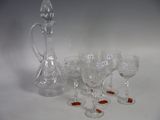 many wine glasses and a decanter on the table