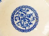 a blue and white plate with a floral design on it