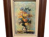 tableau représentant un vase de fleurs dans un cadre marron sur fond blanc