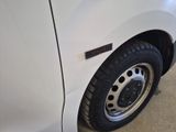 a close up of a white truck with a flat tire