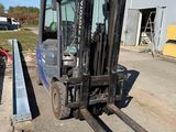 a fork lift truck parked in front of a building