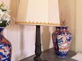 two vases and a lamp on a table in a room